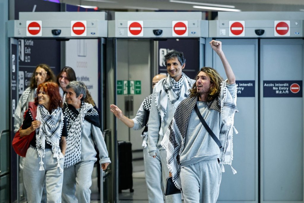 French activists detained and deported by Israel following the interception of their Gaza-bound flotilla arrive at Roissy Charles de Gaulle airport near Paris on May 22, 2026. The 37 French nationals were among some 430 activists from 40 countries aboard the Global Sumud Flotilla, intercepted by the Israeli navy in international waters on May 18 in the latest string of attempts to break the blockade of the Palestinian territory. (Photo by SIMON WOHLFAHRT / AFP)