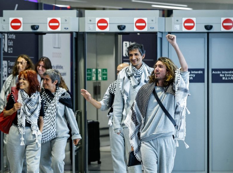 French activists detained and deported by Israel following the interception of their Gaza-bound flotilla arrive at Roissy Charles de Gaulle airport near Paris on May 22, 2026. The 37 French nationals were among some 430 activists from 40 countries aboard the Global Sumud Flotilla, intercepted by the Israeli navy in international waters on May 18 in the latest string of attempts to break the blockade of the Palestinian territory. (Photo by SIMON WOHLFAHRT / AFP)