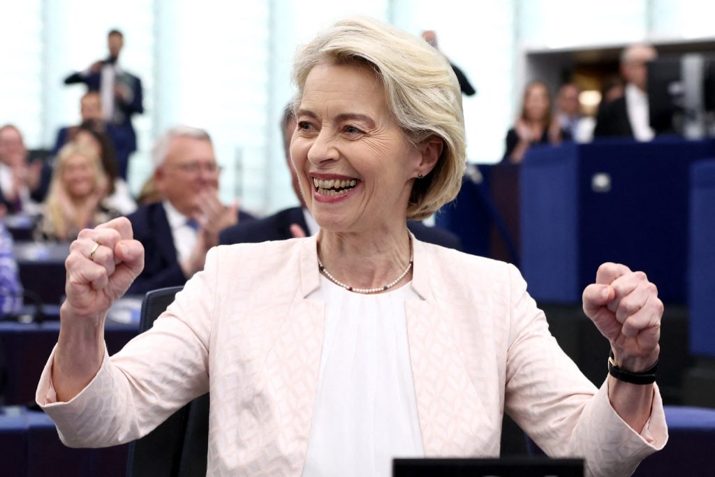 European Commission President Ursula von der Leyen celebrates after she was re-elected for a second term at The European Parliament in Strasbourg, eastern France on July 18, 2024. EU lawmakers on July 18 handed Ursula von der Leyen another five-year term as European Commission president during their first parliamentary session since June elections. Von der Leyen won with the support of 401 MEPs in the 720-seat chamber -- comfortably over the 361-vote majority she needed to remain head of the EU's executive body. There were 284 who voted against in the secret ballot. (Photo by FREDERICK FLORIN / AFP)