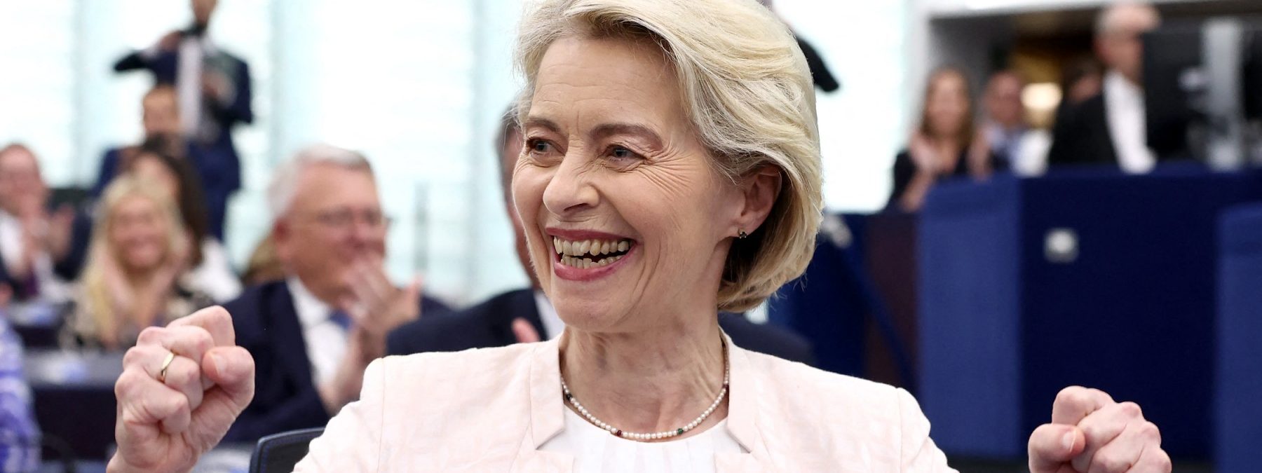European Commission President Ursula von der Leyen celebrates after she was re-elected for a second term at The European Parliament in Strasbourg, eastern France on July 18, 2024. EU lawmakers on July 18 handed Ursula von der Leyen another five-year term as European Commission president during their first parliamentary session since June elections. Von der Leyen won with the support of 401 MEPs in the 720-seat chamber -- comfortably over the 361-vote majority she needed to remain head of the EU's executive body. There were 284 who voted against in the secret ballot. (Photo by FREDERICK FLORIN / AFP)