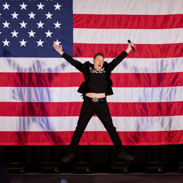 Tesla and SpaceX CEO Elon Musk jumps on stage as he arrives to speak at a town hall event hosted by America PAC in support of former US President and Republican presidential candidate Donald Trump at the Greater Philadelphia Expo Center in Oaks, Pennsylvania, on October 18, 2024. Musk is holding several events in the key swing-state of Pennsylvania in support of former US President and Republican presidential candidate Donald Trump. (Photo by RYAN COLLERD / AFP)