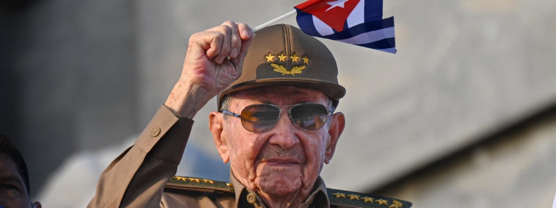 Cuba's former President Raul Castro waves a Cuban national flag during the commemoration of May Day (Labour Day), marking International Workers' Day, at Havana's Revolution Square on May 1, 2025. (Photo by YAMIL LAGE / AFP)