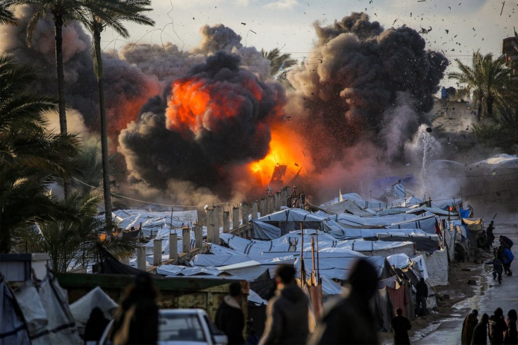 A fireball erupts following an Israeli strike near a tent encampment sheltering people displaced by war in Deir el-Balah in the central Gaza Strip on March 25, 2026. Violence has persisted in Gaza despite a ceasefire which came into effect on October 10, with both Israel and Hamas regularly accusing each other of violations. (Photo by Eyad Baba / AFP)