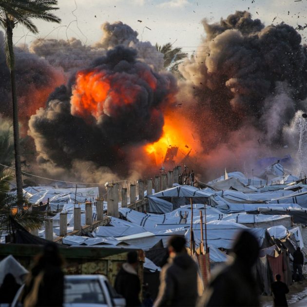 A fireball erupts following an Israeli strike near a tent encampment sheltering people displaced by war in Deir el-Balah in the central Gaza Strip on March 25, 2026. Violence has persisted in Gaza despite a ceasefire which came into effect on October 10, with both Israel and Hamas regularly accusing each other of violations. (Photo by Eyad Baba / AFP)