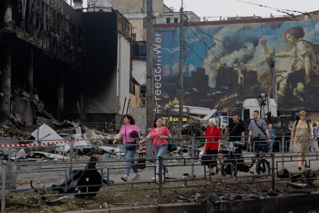 Local residents walk by a damaged shopping center following Russian strikes in Kyiv on May 25, 2026, amid the Russian invasion of Ukraine. (Photo by Tetiana DZHAFAROVA / AFP)