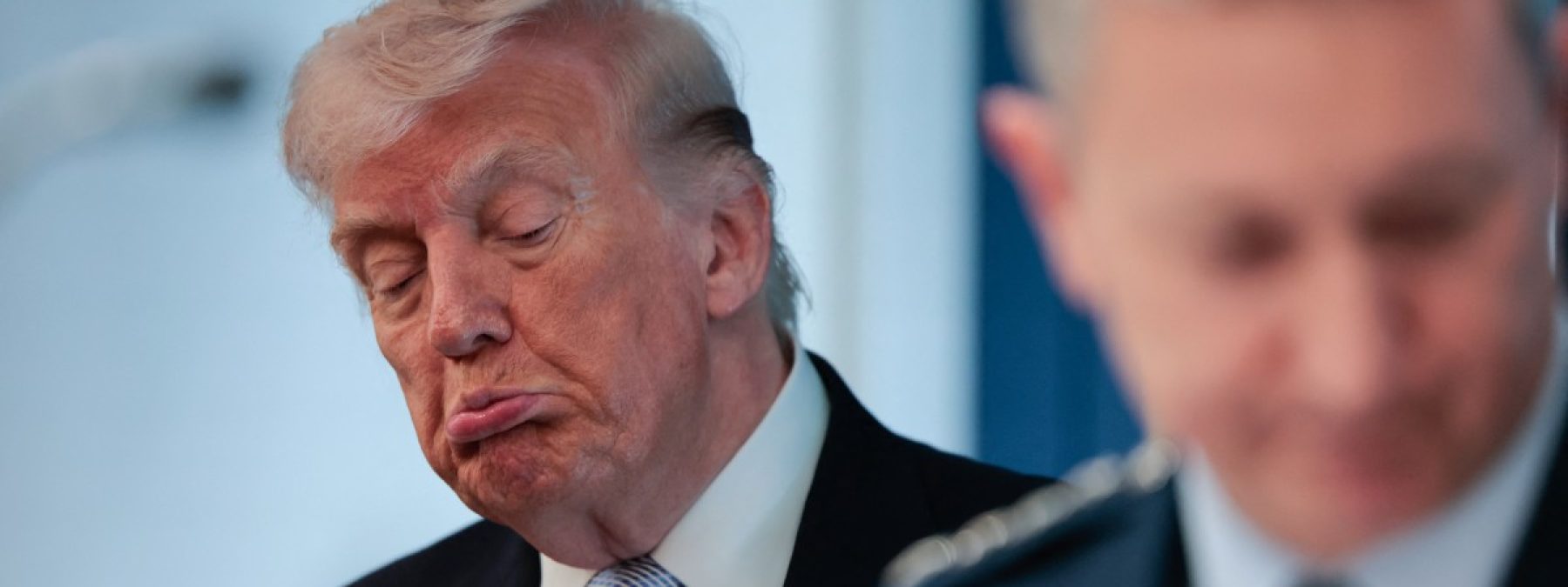 US President Donald Trump (L) looks on as Chairman of the Joint Chiefs of Staff General Dan Caine (R) speaks about the conflict in Iran in the James S. Brady Press Briefing Room of the White House on April 6, 2026, in Washington, DC. (Photo by Kent Nishimura / AFP)