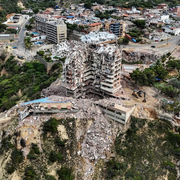 This aerial view shows the Jurel residential building, destroyed during the earthquakes of June 24, in Catia La Mar, Venezuela, on July 20, 2026. The number of people killed in the powerful dual Venezuela earthquakes last month rose to 5,278, according to official figures updated Monday. The June 24 earthquakes, which recorded magnitudes of 7.2 and 7.5, profoundly impacted the north of the country, particularly the coastal state of La Guaira, near the capital Caracas. (Photo by Juan BARRETO / AFP)