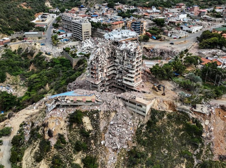 This aerial view shows the Jurel residential building, destroyed during the earthquakes of June 24, in Catia La Mar, Venezuela, on July 20, 2026. The number of people killed in the powerful dual Venezuela earthquakes last month rose to 5,278, according to official figures updated Monday. The June 24 earthquakes, which recorded magnitudes of 7.2 and 7.5, profoundly impacted the north of the country, particularly the coastal state of La Guaira, near the capital Caracas. (Photo by Juan BARRETO / AFP)