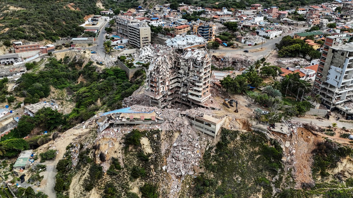 This aerial view shows the Jurel residential building, destroyed during the earthquakes of June 24, in Catia La Mar, Venezuela, on July 20, 2026. The number of people killed in the powerful dual Venezuela earthquakes last month rose to 5,278, according to official figures updated Monday. The June 24 earthquakes, which recorded magnitudes of 7.2 and 7.5, profoundly impacted the north of the country, particularly the coastal state of La Guaira, near the capital Caracas. (Photo by Juan BARRETO / AFP)
