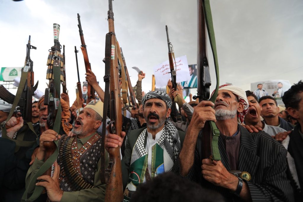 Armed protesters brandish their weapons and placards during a demonstration against the Saudi-led coalition in Sanaa on July 31, 2026. (Photo by MOHAMMED HUWAIS / AFP) /