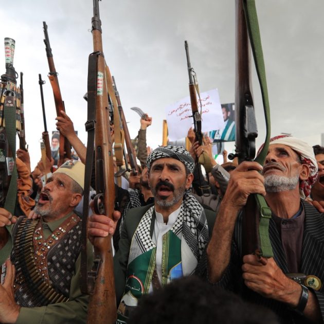 Armed protesters brandish their weapons and placards during a demonstration against the Saudi-led coalition in Sanaa on July 31, 2026. (Photo by MOHAMMED HUWAIS / AFP) /