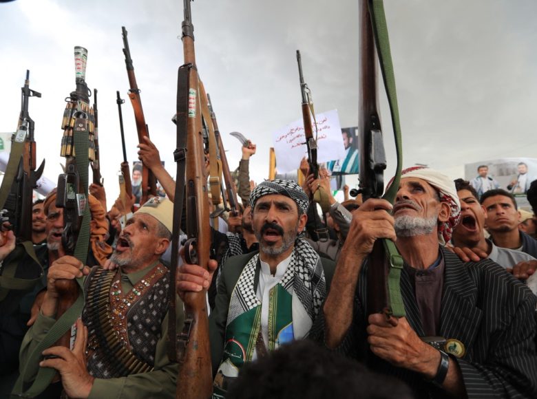 Armed protesters brandish their weapons and placards during a demonstration against the Saudi-led coalition in Sanaa on July 31, 2026. (Photo by MOHAMMED HUWAIS / AFP) /