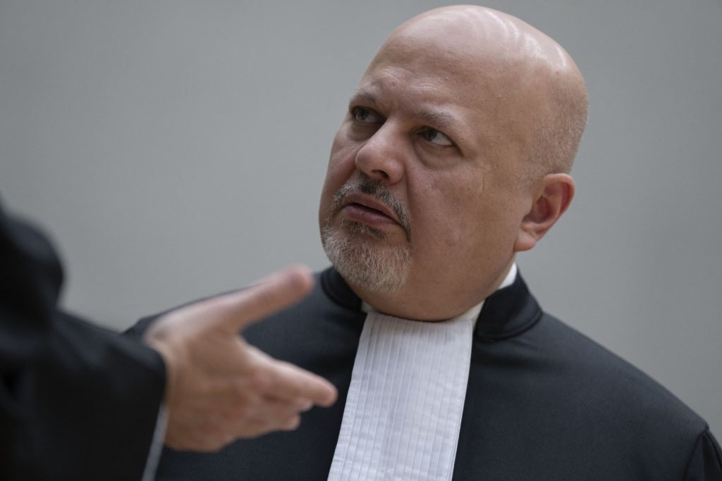 Chief Prosecutor Karim Khan talks prior to the first appearance of former Philippine President Rodrigo Duterte before the International Criminal Court (ICC) on charge of crimes against humanity over his deadly crackdown on narcotics, in The Hague on March 14, 2025. The 79-year-old, the first ex-Asian head of state to face charges at the ICC, followed by videolink during a short hearing to inform him of the crimes he is alleged to have committed, as well as his rights as a defendant. Duterte stands accused of the crime against humanity of murder over his years-long campaign against drug users and dealers that rights groups said killed thousands. (Photo by Peter Dejong / POOL / AFP)