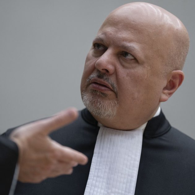Chief Prosecutor Karim Khan talks prior to the first appearance of former Philippine President Rodrigo Duterte before the International Criminal Court (ICC) on charge of crimes against humanity over his deadly crackdown on narcotics, in The Hague on March 14, 2025. The 79-year-old, the first ex-Asian head of state to face charges at the ICC, followed by videolink during a short hearing to inform him of the crimes he is alleged to have committed, as well as his rights as a defendant. Duterte stands accused of the crime against humanity of murder over his years-long campaign against drug users and dealers that rights groups said killed thousands. (Photo by Peter Dejong / POOL / AFP)