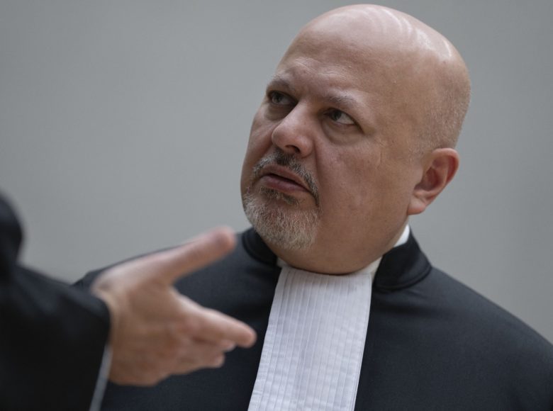 Chief Prosecutor Karim Khan talks prior to the first appearance of former Philippine President Rodrigo Duterte before the International Criminal Court (ICC) on charge of crimes against humanity over his deadly crackdown on narcotics, in The Hague on March 14, 2025. The 79-year-old, the first ex-Asian head of state to face charges at the ICC, followed by videolink during a short hearing to inform him of the crimes he is alleged to have committed, as well as his rights as a defendant. Duterte stands accused of the crime against humanity of murder over his years-long campaign against drug users and dealers that rights groups said killed thousands. (Photo by Peter Dejong / POOL / AFP)