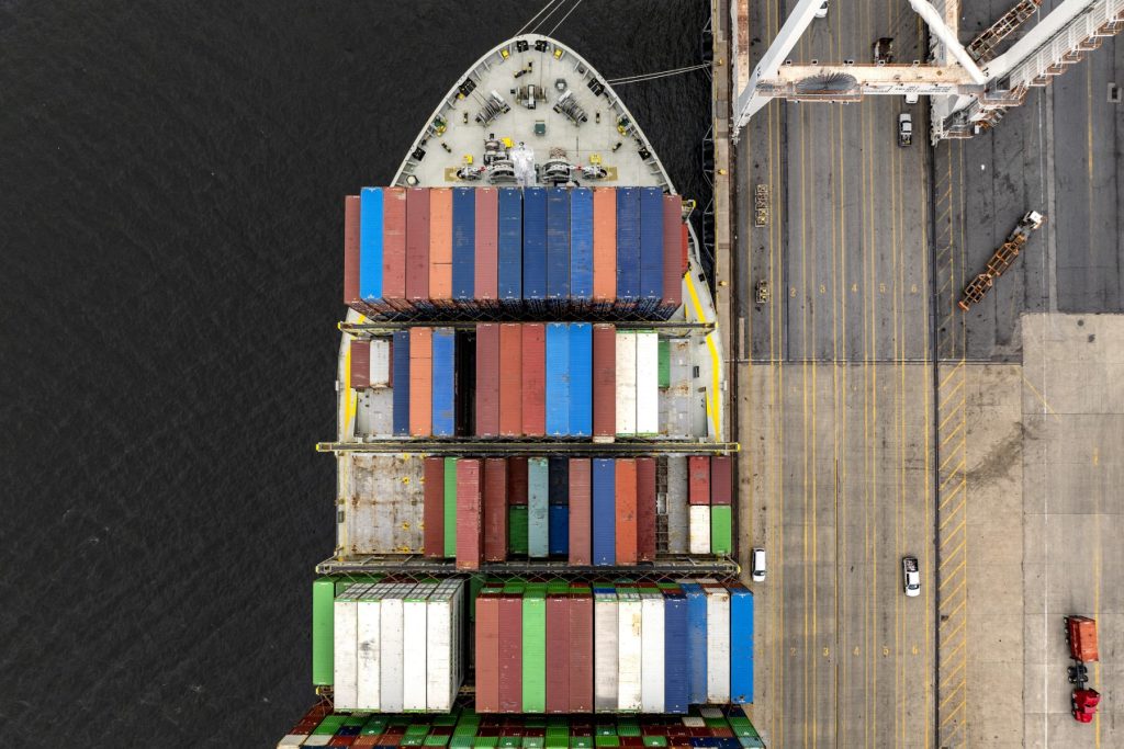This aerial view shows a cargo ship carrying shipping containers moored to the pier at the Port of Baltimore on April 10, 2025, in Baltimore, Maryland. US President Donald Trump's 10 percent tariff for almost all countries except China will likely remain in place going forward, his top economic advisor Kevin Hassett said Thursday. On April 8, Trump announced a 90-day pause on higher tariffs against all countries except China, reversing a policy that had roiled global stock markets and spooked the American bond markets -- a key barometer of investors' faith in the US government's ability to pay its debts. (Photo by Jim WATSON / AFP)