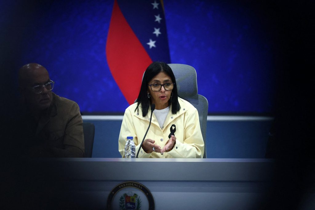 Venezuela's interim President Delcy Rodriguez (C) speaks during a press conference alongside National Assembly President Jorge Rodriguez (L) and Interior Minister Diosdado Cabello (unseen) at the Generalisimo Francisco de Miranda Air Base in Caracas on July 2, 2026. At least 2,595 people have died as a result of the twin earthquakes that struck Venezuela on June 24, interim President Delcy Rodriguez announced on July 2, adding that all of the victims will be properly identified. (Photo by Lucas AGUAYO / AFP)