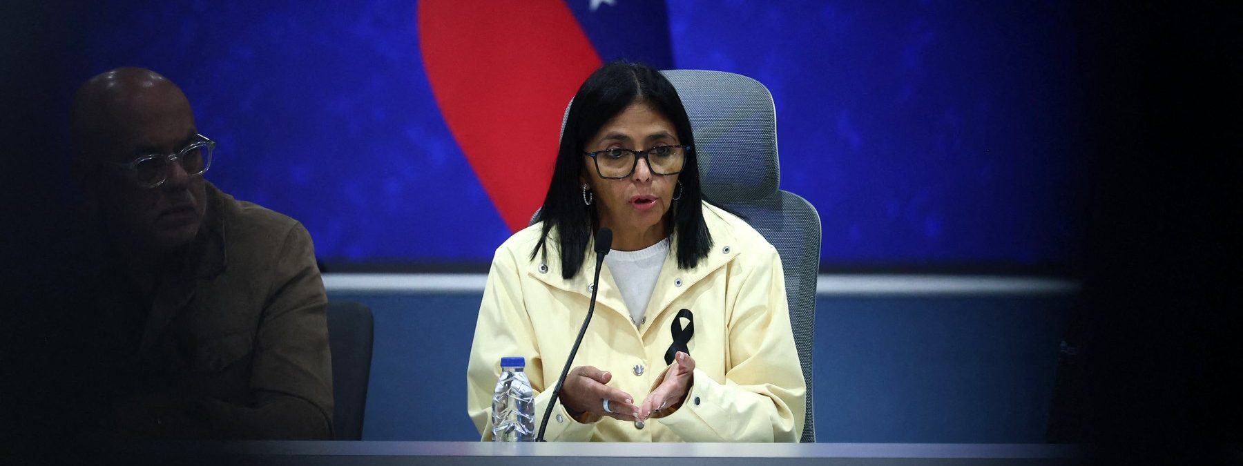 Venezuela's interim President Delcy Rodriguez (C) speaks during a press conference alongside National Assembly President Jorge Rodriguez (L) and Interior Minister Diosdado Cabello (unseen) at the Generalisimo Francisco de Miranda Air Base in Caracas on July 2, 2026. At least 2,595 people have died as a result of the twin earthquakes that struck Venezuela on June 24, interim President Delcy Rodriguez announced on July 2, adding that all of the victims will be properly identified. (Photo by Lucas AGUAYO / AFP)