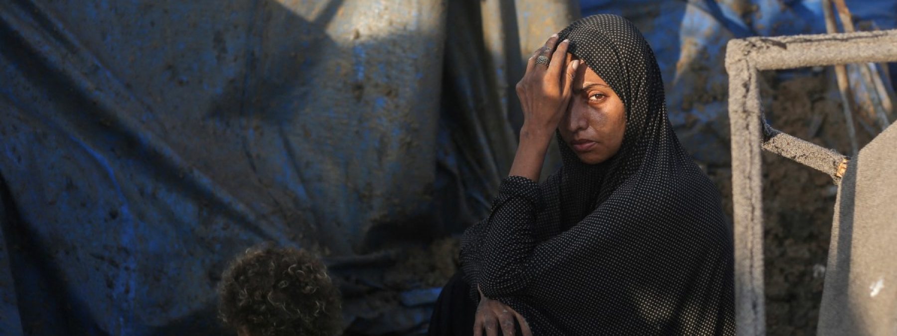 A displaced Palestinians sits outside tents following an Israeli airstrike that targeted the medical supplies and pharmaceuticals warehouse of Al-Aqsa Martyrs Hospital, in Deir al-Balah, central Gaza Strip on August 1, 2026. Hamas said on July 31, 2026, it had agreed to a deal that includes handing over its weapons to a Palestinian governing committee and the gradual withdrawal of Israeli forces from the Gaza Strip. Israel has yet to officially comment on the announcement, but a political source told AFP "that there will be no withdrawal whatsoever" from Israeli forces' current lines "unless Hamas undergoes a genuine disarmament". (Photo by Eyad Baba / AFP)