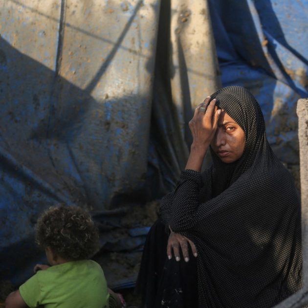 A displaced Palestinians sits outside tents following an Israeli airstrike that targeted the medical supplies and pharmaceuticals warehouse of Al-Aqsa Martyrs Hospital, in Deir al-Balah, central Gaza Strip on August 1, 2026. Hamas said on July 31, 2026, it had agreed to a deal that includes handing over its weapons to a Palestinian governing committee and the gradual withdrawal of Israeli forces from the Gaza Strip. Israel has yet to officially comment on the announcement, but a political source told AFP "that there will be no withdrawal whatsoever" from Israeli forces' current lines "unless Hamas undergoes a genuine disarmament". (Photo by Eyad Baba / AFP)