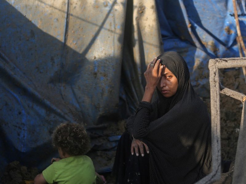 A displaced Palestinians sits outside tents following an Israeli airstrike that targeted the medical supplies and pharmaceuticals warehouse of Al-Aqsa Martyrs Hospital, in Deir al-Balah, central Gaza Strip on August 1, 2026. Hamas said on July 31, 2026, it had agreed to a deal that includes handing over its weapons to a Palestinian governing committee and the gradual withdrawal of Israeli forces from the Gaza Strip. Israel has yet to officially comment on the announcement, but a political source told AFP "that there will be no withdrawal whatsoever" from Israeli forces' current lines "unless Hamas undergoes a genuine disarmament". (Photo by Eyad Baba / AFP)