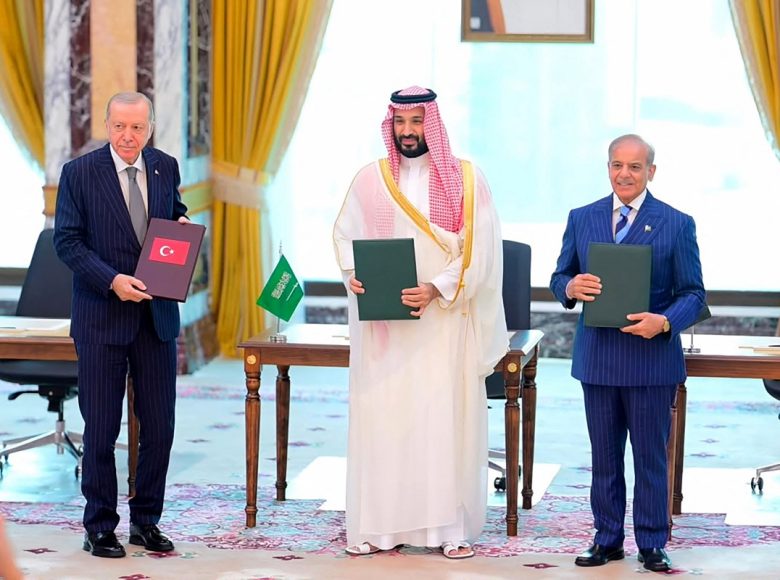 This handout photograph taken and released by Pakistan's Prime Minister's Office on August 7, 2026 shows Saudi Crown Prince Mohammed bin Salman (C), Turkish President Recep Tayyip Erdogan (L) and Pakistani Prime Minister Shehbaz Sharif posing after signing the Mecca Joint Defence Agreement in Mecca, Saudi Arabia. Saudi Arabia, Turkey and Pakistan signed a joint defence agreement on August 7 amid violence in the region from Houthi attacks and the US-Iran war. (Photo by Handout / Pakistan Prime Minister's Office / AFP) / RESTRICTED TO EDITORIAL USE - MANDATORY CREDIT "AFP PHOTO /Pakistan Prime Minister's Office/ HANDOUT / " - NO MARKETING NO ADVERTISING CAMPAIGNS - DISTRIBUTED AS A SERVICE TO CLIENTS