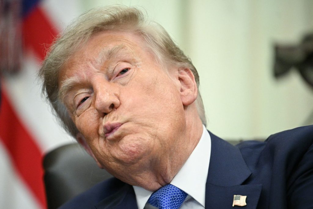 US President Donald Trump looks on before signing an executive order calling for more research and flexibility on vaccines, in the Oval Office of the White House in Washington, DC, on August 10, 2026. Trump signed an executive order Monday pushing for a rethink of school vaccine mandates and repeating calls for the measles-mumps-rubella vaccine to be separated into three individual shots. Curbing vaccines has been a key priority for Health Secretary Robert F. Kennedy Jr, who founded an anti-vaccine nonprofit and has long promoted a disproven link between immunization and autism. (Photo by Jim WATSON / AFP)