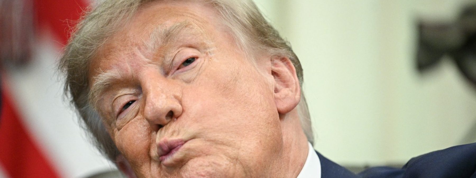 US President Donald Trump looks on before signing an executive order calling for more research and flexibility on vaccines, in the Oval Office of the White House in Washington, DC, on August 10, 2026. Trump signed an executive order Monday pushing for a rethink of school vaccine mandates and repeating calls for the measles-mumps-rubella vaccine to be separated into three individual shots. Curbing vaccines has been a key priority for Health Secretary Robert F. Kennedy Jr, who founded an anti-vaccine nonprofit and has long promoted a disproven link between immunization and autism. (Photo by Jim WATSON / AFP)