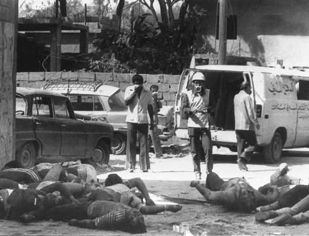 Bodies of Palestinians killed 17 September 1982 in the refugee camp of Sabra lie 18 September in the middle of a road as civil defense workers prepare to take them away. Lebanese Christian militia began 17 September a bloody massacre in the Palestinian refugee camps of Sabra and Shatila in West Beirut. Hundreds have been killed in the slaughter which was carried out in revenge of the assassination four days ago of Bashir Gemayel, the President-elect of Lebanon. The Israeli army was blamed for allowing the killers to go about their dreadful work. (FILM) (Photo by SANA / AFP)