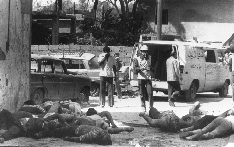 Bodies of Palestinians killed 17 September 1982 in the refugee camp of Sabra lie 18 September in the middle of a road as civil defense workers prepare to take them away. Lebanese Christian militia began 17 September a bloody massacre in the Palestinian refugee camps of Sabra and Shatila in West Beirut. Hundreds have been killed in the slaughter which was carried out in revenge of the assassination four days ago of Bashir Gemayel, the President-elect of Lebanon. The Israeli army was blamed for allowing the killers to go about their dreadful work. (FILM) (Photo by SANA / AFP)
