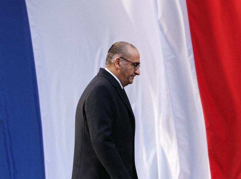 France's Interior Minister Laurent Nunez looks down in front of the French flag during the installation ceremony of the new Paris Police Prefect, in Paris, on October 27, 2025. (Photo by Thomas SAMSON / AFP)
