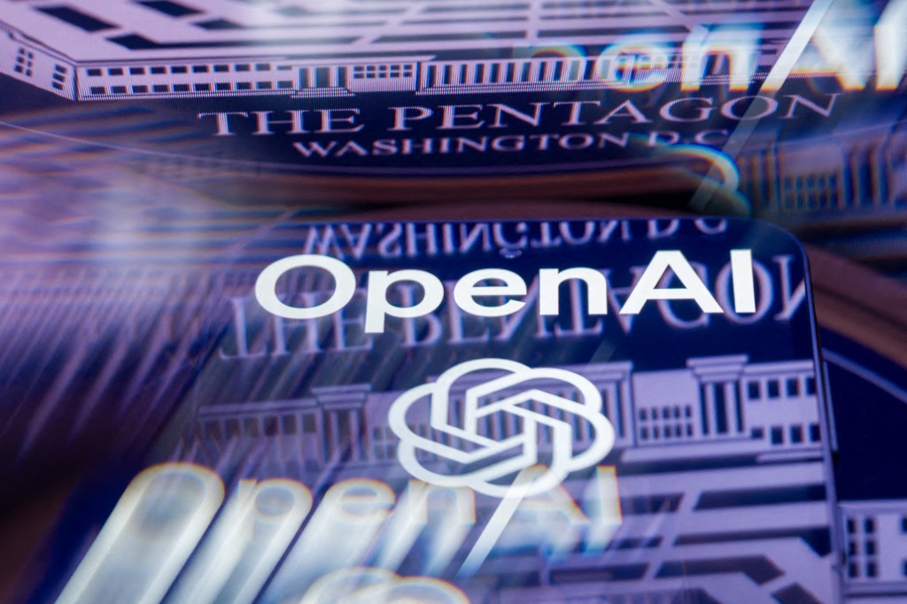 The OpenAI logo is displayed on a smartphone with the seal of the U.S. Department of Defense (Pentagon) reflected on a surface in this photo illustration, as the AI company revises an agreement to provide technology to the Pentagon following criticism and debate over the military use of artificial intelligence in Brussels, Belgium, on March 7, 2026. (Photo by Jonathan Raa/NurPhoto) (Photo by Jonathan Raa / NurPhoto via AFP)