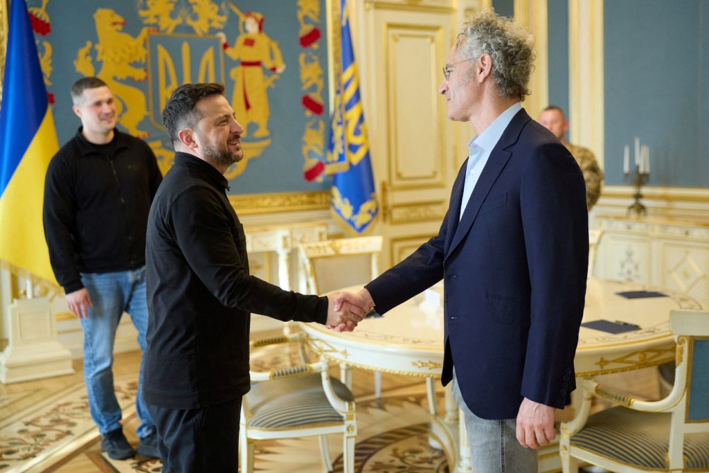 This handout photograph taken and released by the Ukrainian Presidential Press Service on May 12, 2026, shows Ukraine's President Volodymyr Zelensky and CEO of AI firm Palantir Alex Karp shaking hands during their meeting in Kyiv, amid the Russian invasion of Ukraine. (Photo by Handout / UKRAINIAN PRESIDENTIAL PRESS SERVICE / AFP) / XGTY / RESTRICTED TO EDITORIAL USE - MANDATORY CREDIT "AFP PHOTO / UKRAINIAN PRESIDENTIAL PRESS SERVICE" - NO MARKETING NO ADVERTISING CAMPAIGNS - DISTRIBUTED AS A SERVICE TO CLIENTS
