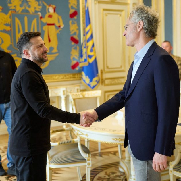 This handout photograph taken and released by the Ukrainian Presidential Press Service on May 12, 2026, shows Ukraine's President Volodymyr Zelensky and CEO of AI firm Palantir Alex Karp shaking hands during their meeting in Kyiv, amid the Russian invasion of Ukraine. (Photo by Handout / UKRAINIAN PRESIDENTIAL PRESS SERVICE / AFP) / XGTY / RESTRICTED TO EDITORIAL USE - MANDATORY CREDIT "AFP PHOTO / UKRAINIAN PRESIDENTIAL PRESS SERVICE" - NO MARKETING NO ADVERTISING CAMPAIGNS - DISTRIBUTED AS A SERVICE TO CLIENTS
