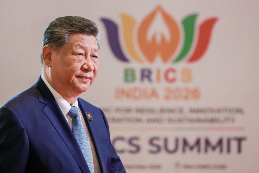In this pool photograph distributed by the Russian state agency Sputnik, China's President Xi Jinping arrives before the start of the 18th BRICS Summit in New Delhi on September 12, 2026. (Photo by Alexander KAZAKOV / POOL / AFP)