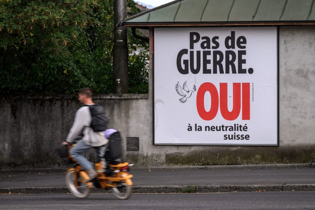 An electoral poster reads "No war, Yes to Swiss neutrality" on a street of Lausanne, western Switzerland on September 19, 2026. On September 27, 2026, Swiss citizens will vote on a popular initiative seeking to enshrine Switzerlands perpetual and armed neutrality in the Federal Constitution and limit participation in military alliances and sanctions against belligerent states. (Photo by Fabrice COFFRINI / AFP)