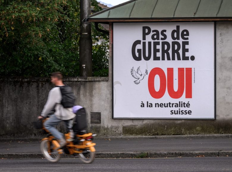 An electoral poster reads "No war, Yes to Swiss neutrality" on a street of Lausanne, western Switzerland on September 19, 2026. On September 27, 2026, Swiss citizens will vote on a popular initiative seeking to enshrine Switzerlands perpetual and armed neutrality in the Federal Constitution and limit participation in military alliances and sanctions against belligerent states. (Photo by Fabrice COFFRINI / AFP)