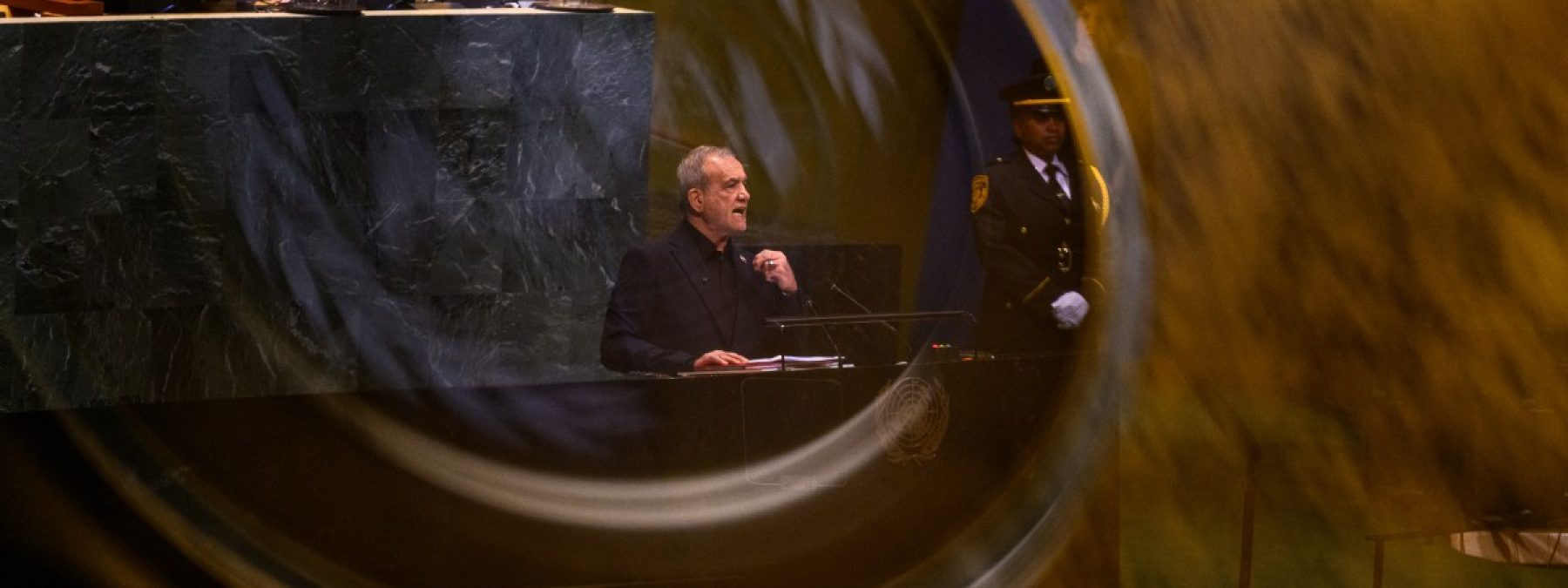 NEW YORK, NEW YORK - SEPTEMBER 23:  (EDITOR'S NOTE: Image was captured in camera using a reflection on a mobile device) President of Iran Masoud Pezeshkian speaks during the 81st session of the United Nations (U.N.) General Assembly at U.N. Headquarters on September 23, 2026 in New York City. World leaders have gathered in New York for the annual session of the United Nations General Assembly, with this year's global issues ranging from the threat of artificial intelligence to the continued wars in Ukraine, Iran and Gaza. Alexi J. Rosenfeld/Getty Images/AFP (Photo by Alexi J. Rosenfeld / GETTY IMAGES NORTH AMERICA / Getty Images via AFP)