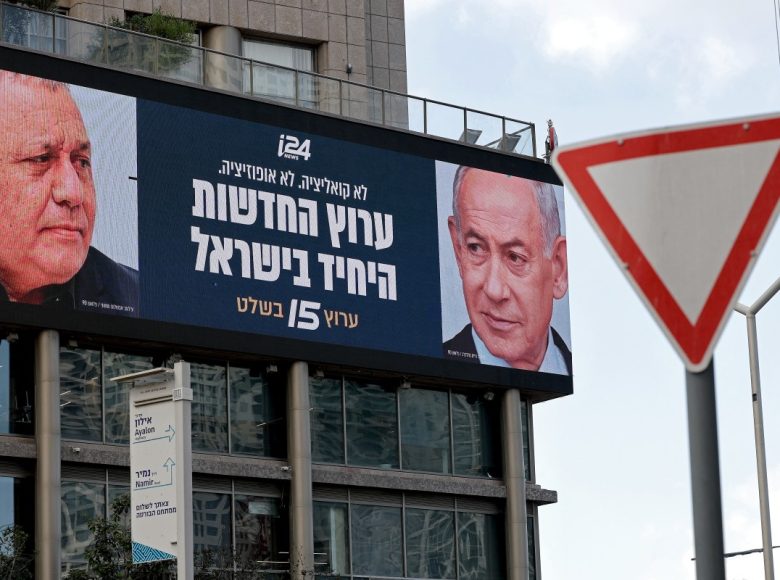 An advertisement featuring Israel's Prime Minister Benjamin Netanyahu (R) of the Likud party and country's former chief of the general staff and leader of the Yashar centrist political party Gadi Eisenkot, is pictured next to a traffic sign board along a street in Ramat Gan on September 23, 2026. Israel heads to the polls on October 27 in its first election since the October 7, 2023 Hamas-led attack, in what is seen as a referendum on Netanyahu. (Photo by Jack GUEZ / AFP)
